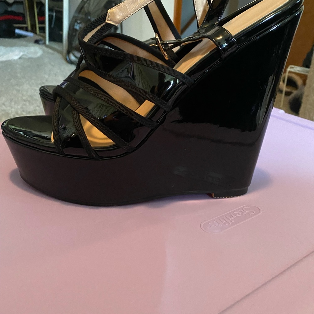 Women’s size 14 Black high heel wedges. Like new. Open toe. Buckles.
